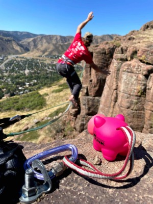 Man highlining in front of piggy bank on mountains
