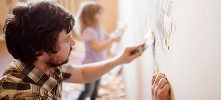 Father and Daughter painting wall