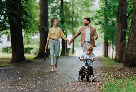 Family walking through a park on a fall day. 