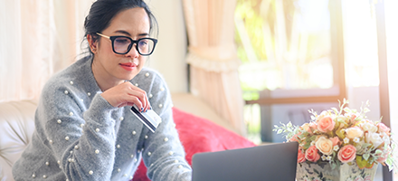 Hispanic woman looking at laptop screen. 