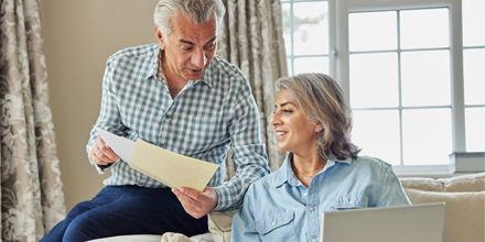 Smiling couple looking at finances at home