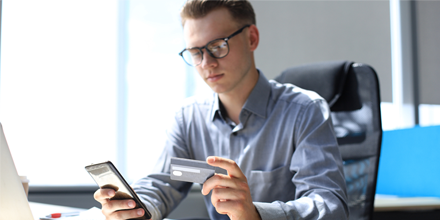 Man paying with credit card on his smart phone