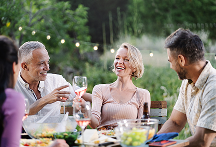 Group of friends eating dinner in backyard