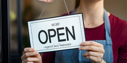 Business owner switching sign to open